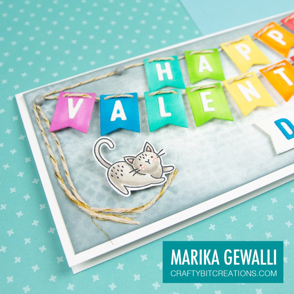 Close up of left side of Slimeline card showing a colored cartoon cat and the letters VALEHAP on rainbow banner flags