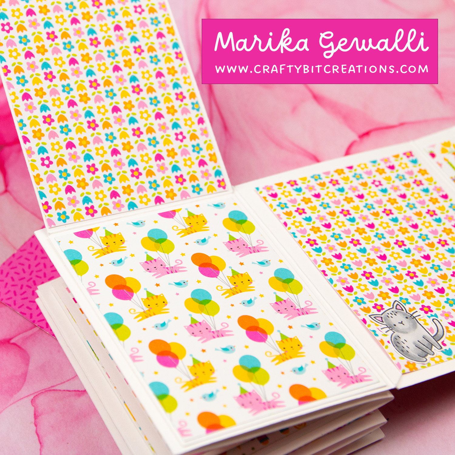 Close up of fifth spread of accordion album decorated with colorful pattern paper and a stamped cat