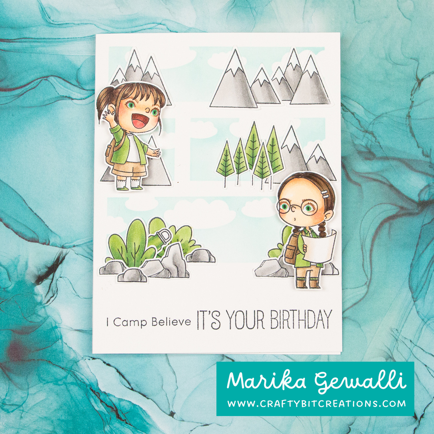 Handmade greeting card with sentiment I Camp Believe It's Your Birthday Three levels with mountains, trees, burshes and stones. Two girls, on on the next to top level waving and one on the bottom level reading a map