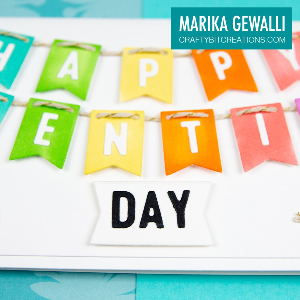 Close up of middle of Slimeline card showing a colored cartoon cat and the letters on rainbow banner flags