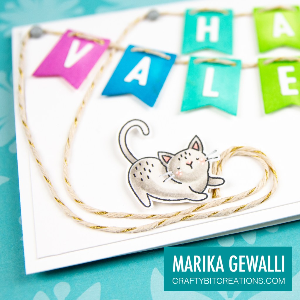 Close up of left side of Slimeline card showing a colored cartoon cat and the letters on rainbow banner flags