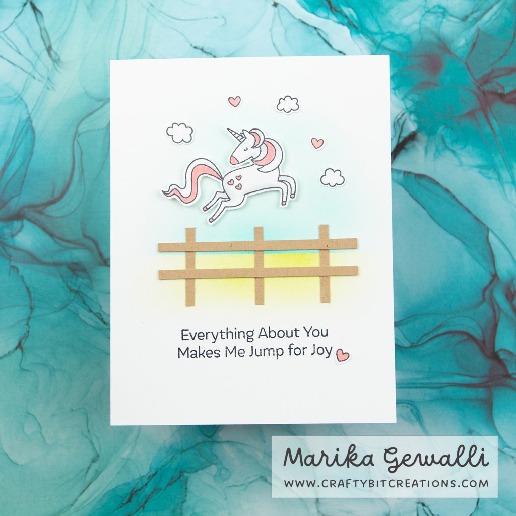Showing greeting card that says Everything About You Makes Me Jump for Joy and the image above it is a unicorn hopping over a fence with clouds and hearts in the background.