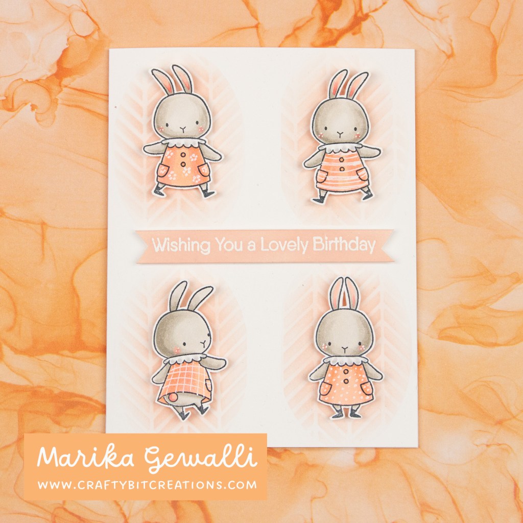 Greeting card for birthday with stamped bunnies with dresses in four corners