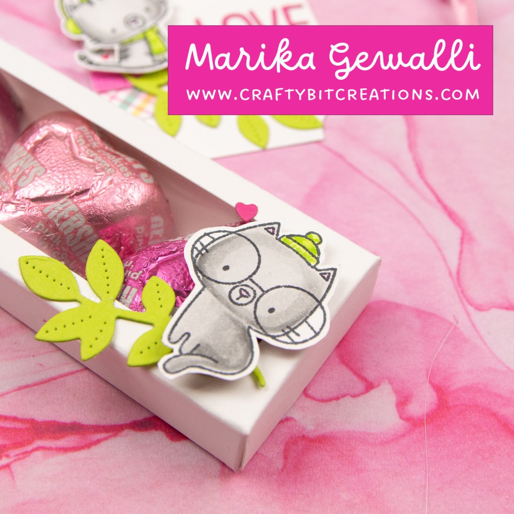 close up white decorated box with 4 hershey's hearts inside and a coordinating tag