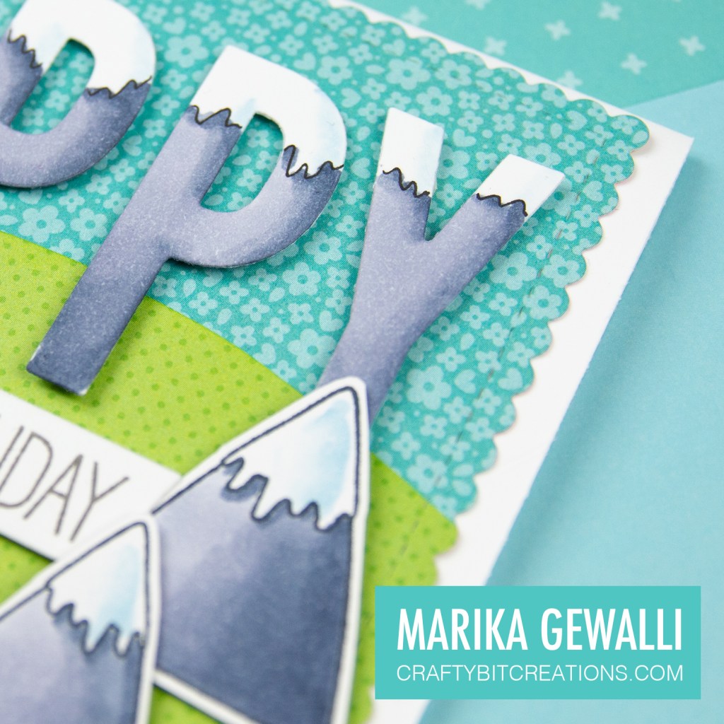 Close up of prehistoric Birthday Card showing letters coloured like mountains