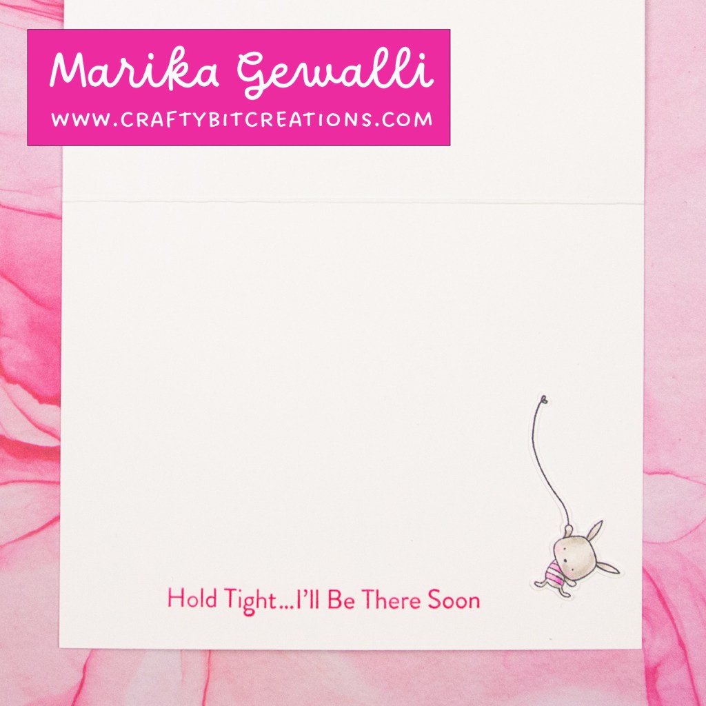 inside of card showing a sentiment saying "hold tight...I'll be there soon" with a bunny hanging in a string beside it.