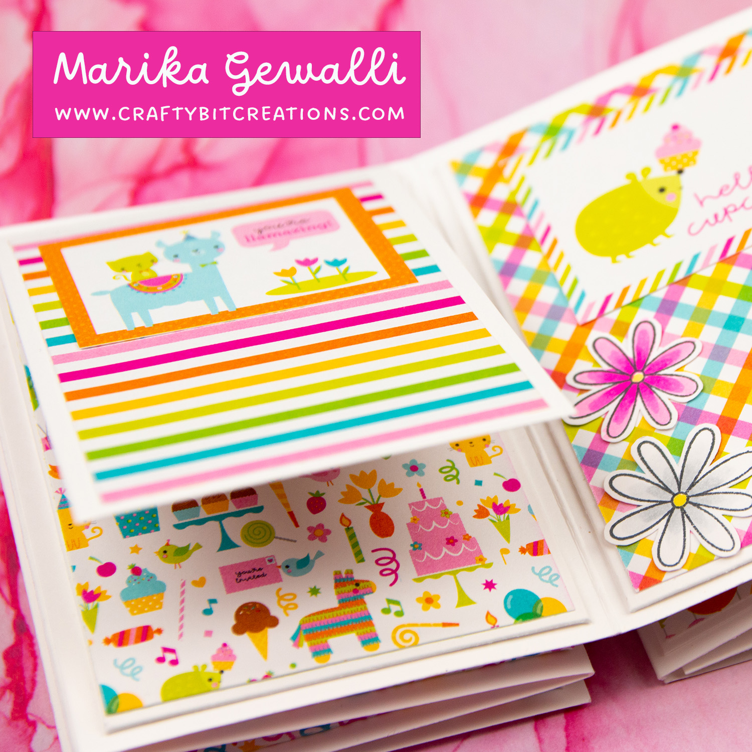 Close up of sixth spread of accordion album decorated with colorful pattern paper and a stamped cat